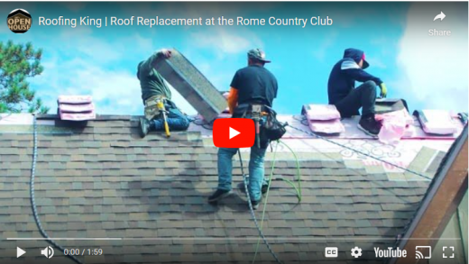 workers on a roof with tools and shingles.